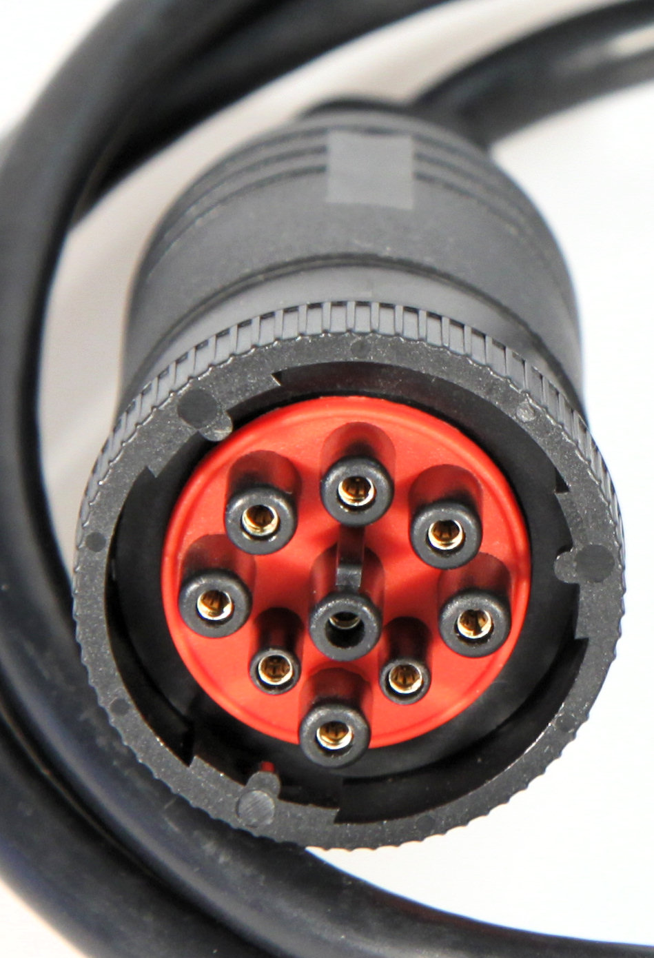 A round Deutsch HD-style 9-pin J1939 diagnostic plug with threaded coupling on a black cable