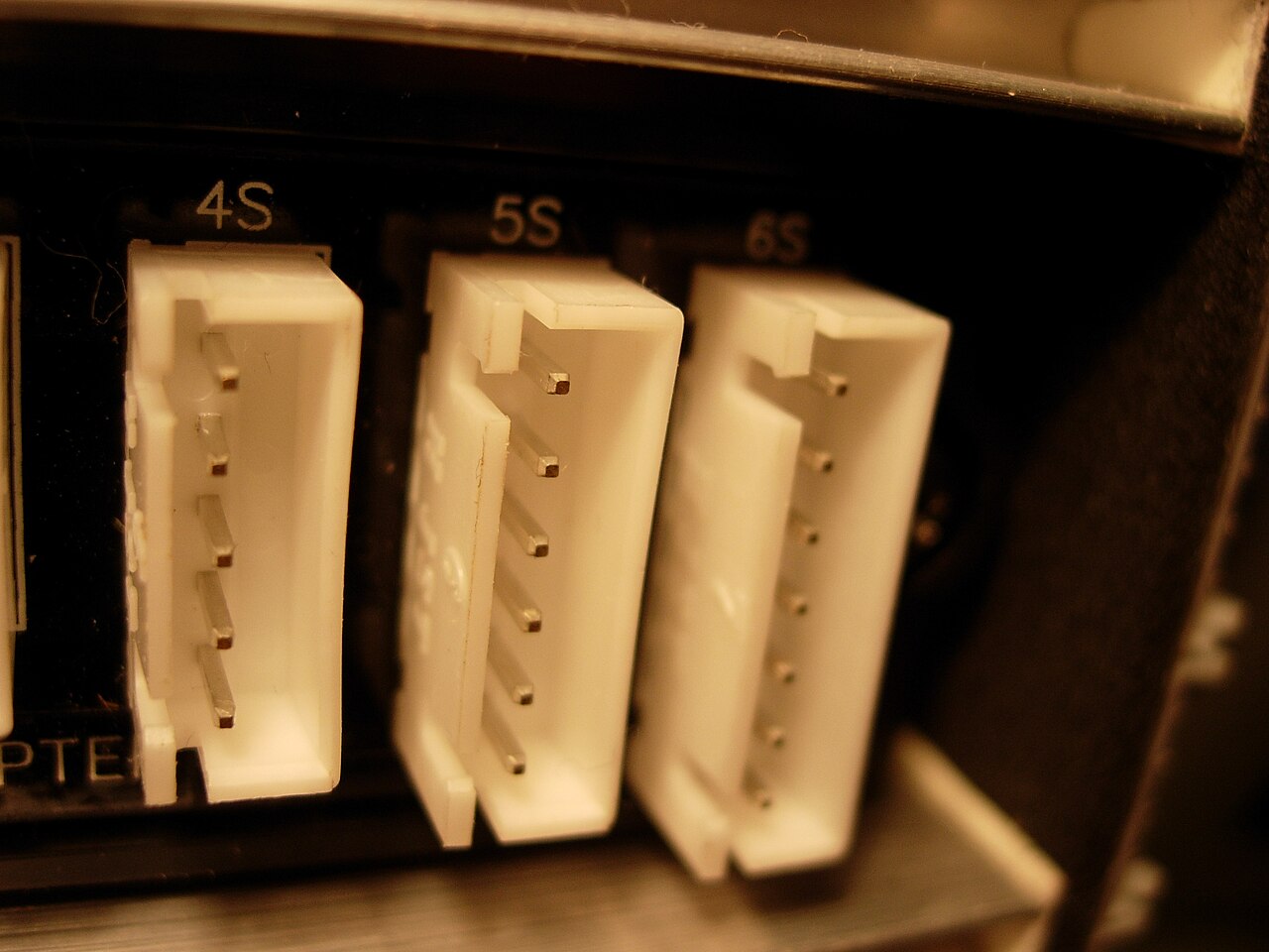 Close-up of 4S, 5S, and 6S XH balance ports on a battery charger, showing the white shrouded headers and pins