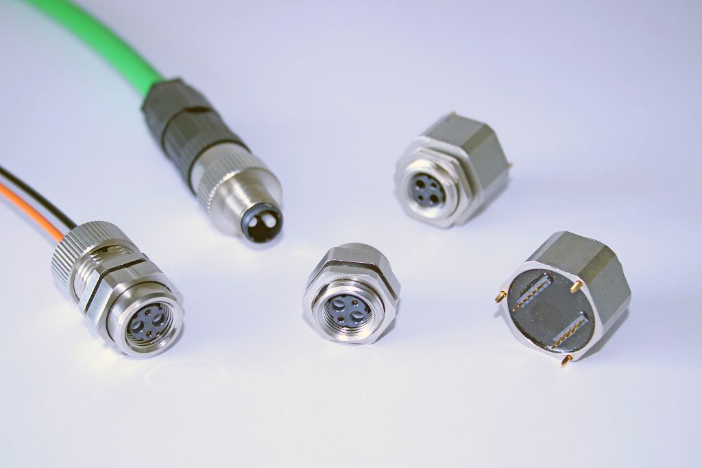 A molded M12 plug on a green cable beside an M8 cordset and M12/M8 panel-mount receptacles