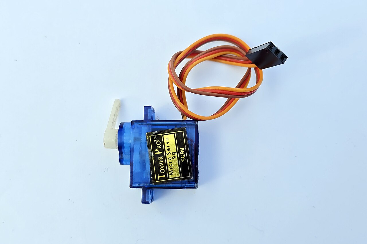 An SG90 micro servo with its three-wire lead ending in a 3-pin 0.1-inch-class servo plug