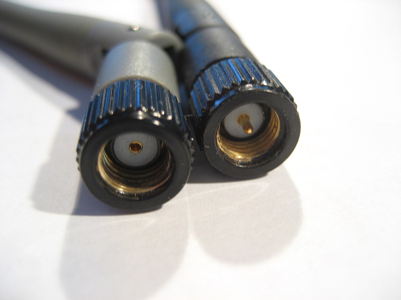 Two antenna connectors side by side, one with a center socket and one with a center pin, otherwise identical